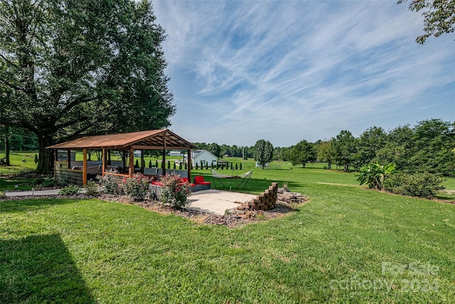 view of home's community with a lawn, a gazebo, and a patio