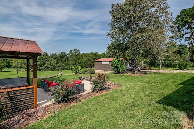 view of yard with a storage shed, a wooden deck, a patio, and an outbuilding