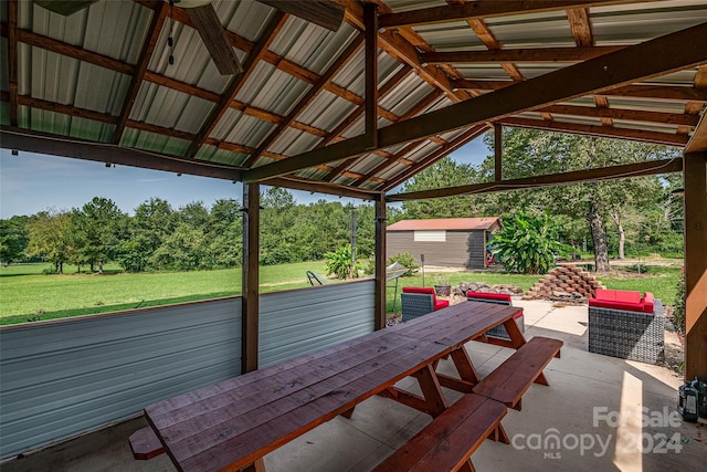 view of patio with a gazebo, a shed, outdoor dining area, and an outdoor structure