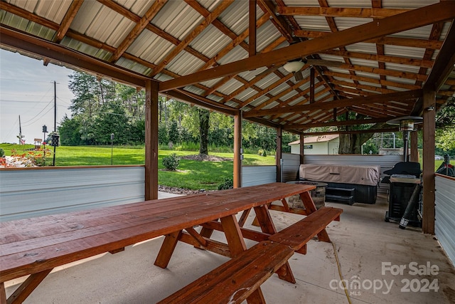 view of patio / terrace featuring a hot tub and a gazebo