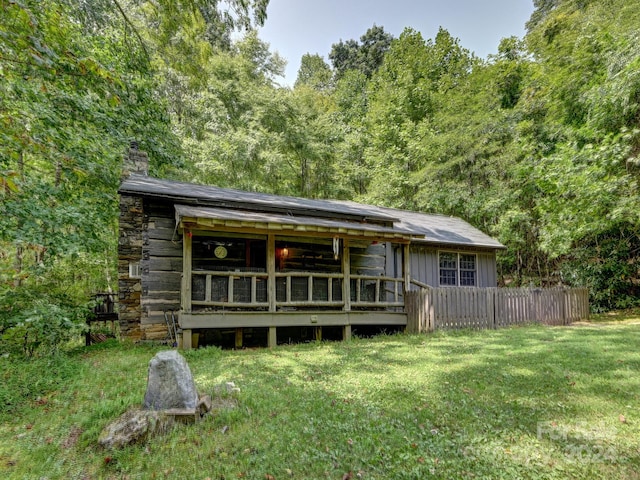 back of house with a lawn