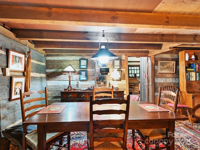 dining area featuring beamed ceiling, wood walls, and wooden ceiling