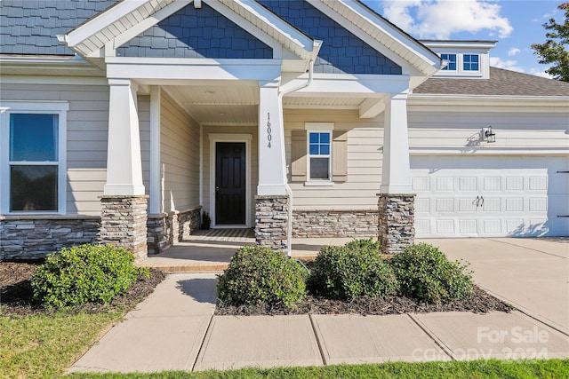 view of exterior entry with a garage