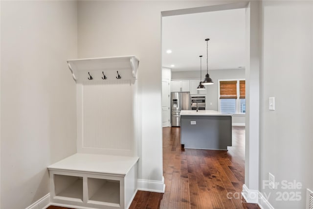 mudroom featuring dark wood-type flooring, recessed lighting, visible vents, and baseboards