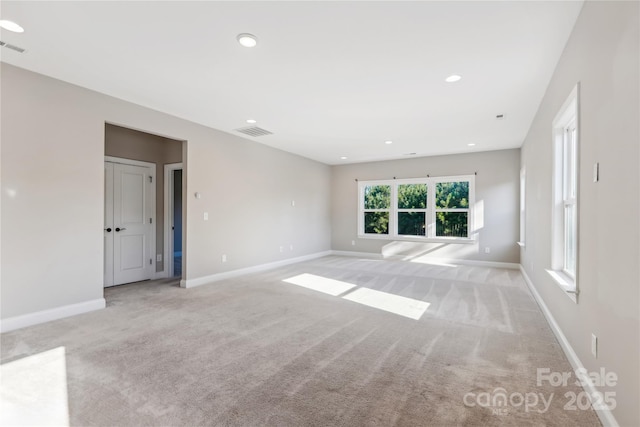 spare room with recessed lighting, visible vents, baseboards, and light colored carpet