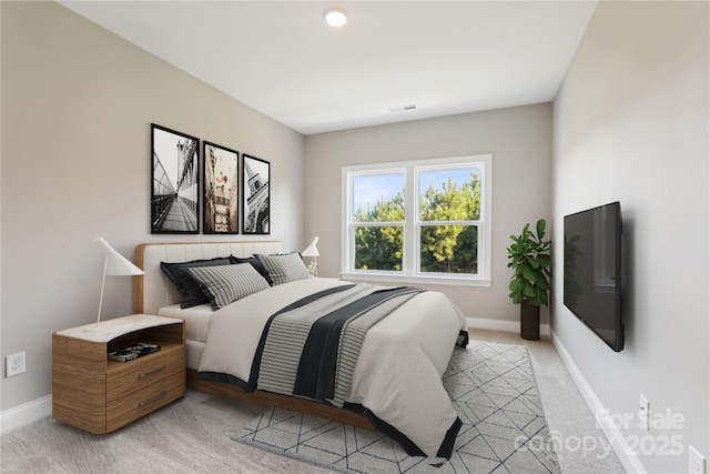 bedroom with visible vents, baseboards, and light colored carpet