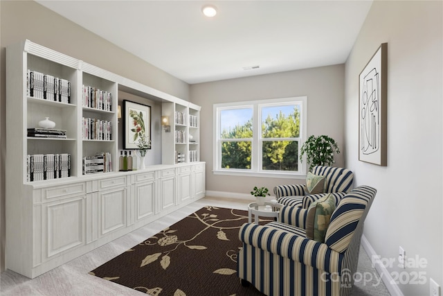 living area featuring visible vents and baseboards