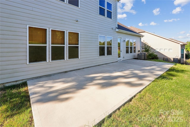 exterior space featuring fence, cooling unit, and a patio