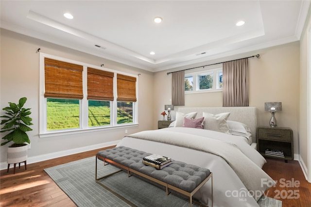 bedroom featuring a raised ceiling, visible vents, dark wood finished floors, and baseboards