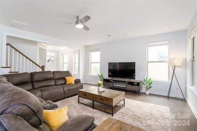 living room featuring plenty of natural light and ceiling fan