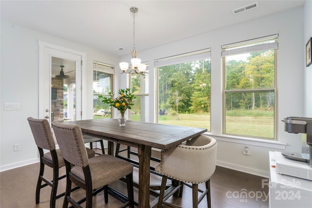 dining area featuring an inviting chandelier and dark hardwood / wood-style flooring