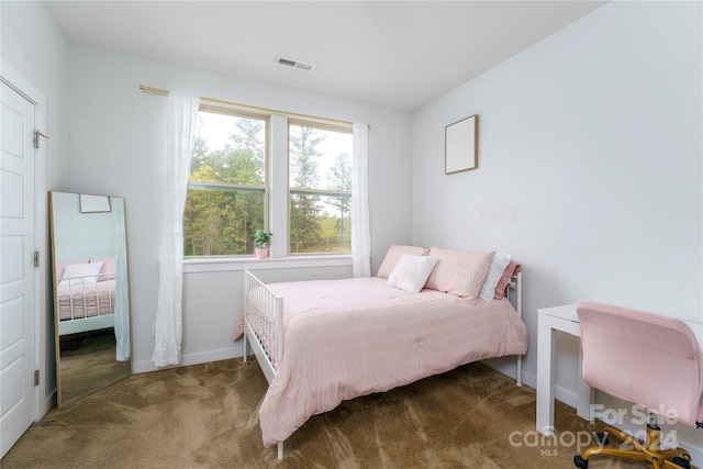 bedroom featuring dark colored carpet