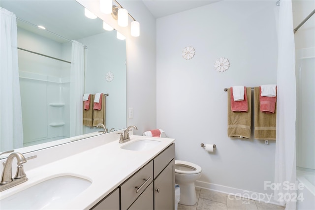 full bathroom featuring shower / bath combo with shower curtain, toilet, tile patterned flooring, and vanity