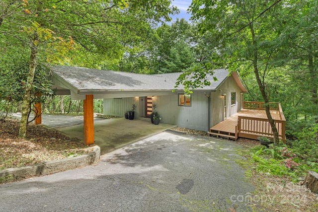 view of front of house with a deck and a carport