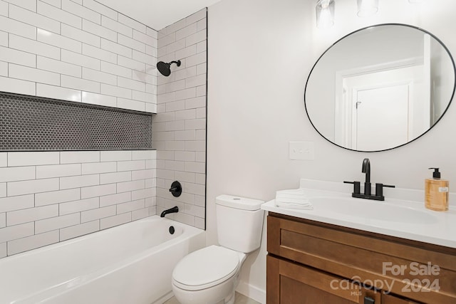 full bathroom featuring toilet, vanity, and tiled shower / bath