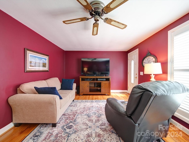 living room featuring ceiling fan and light hardwood / wood-style floors