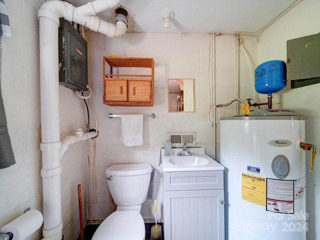 bathroom featuring vanity, water heater, tile walls, toilet, and electric panel