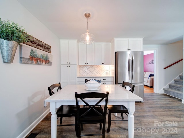 dining area featuring dark wood-type flooring