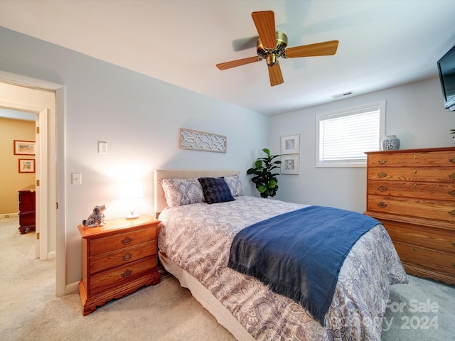 bedroom with ceiling fan and light carpet