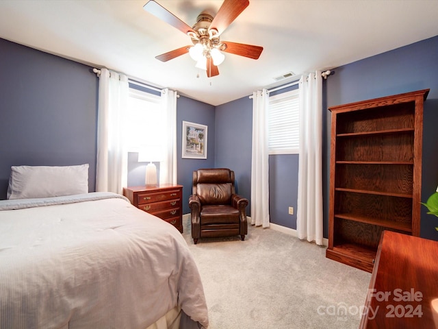 bedroom featuring light carpet and ceiling fan