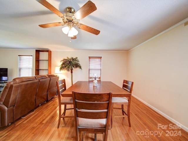 dining room featuring crown molding, ceiling fan, and light wood-type flooring