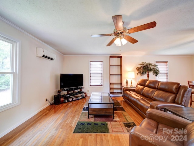 living room featuring a wealth of natural light, light hardwood / wood-style flooring, ceiling fan, and ornamental molding