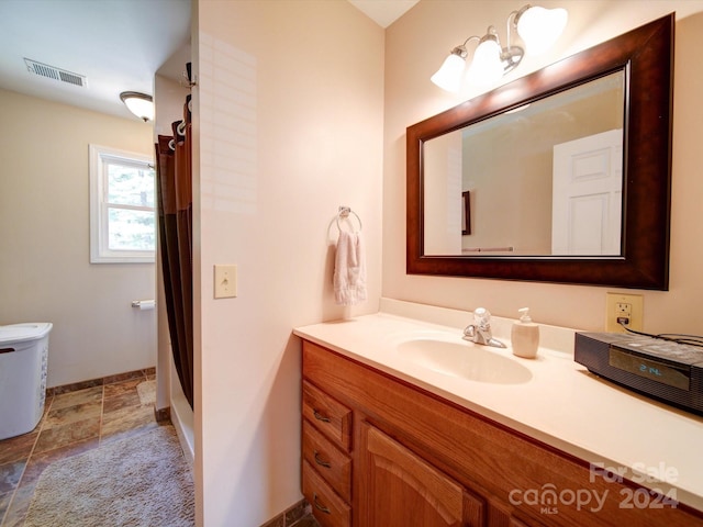 bathroom with toilet and vanity