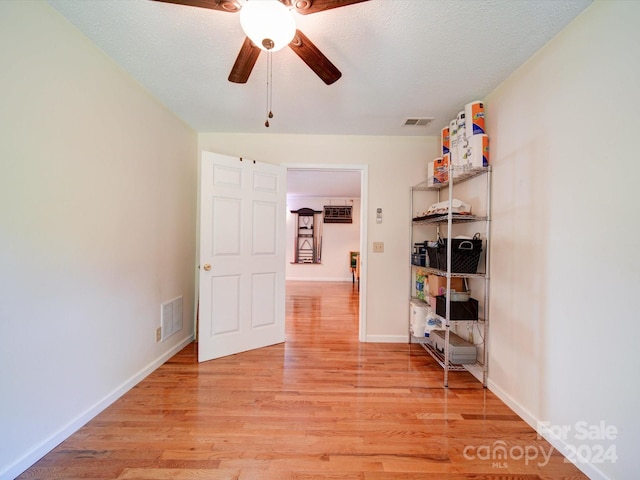 unfurnished bedroom with a textured ceiling, ceiling fan, and light hardwood / wood-style floors