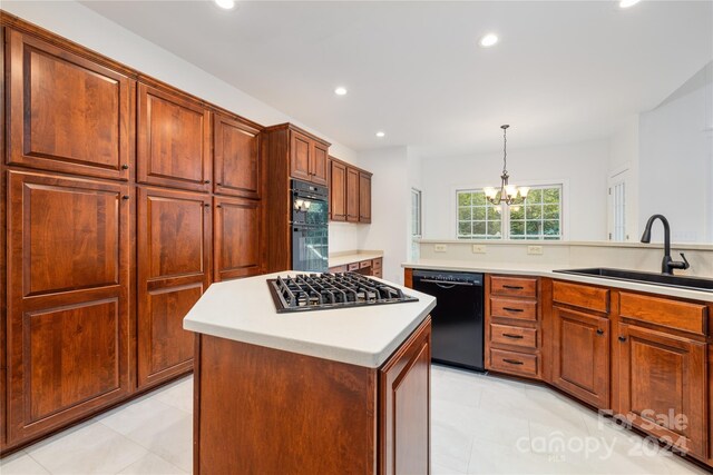 kitchen featuring sink, a center island, light tile patterned floors, and black appliances