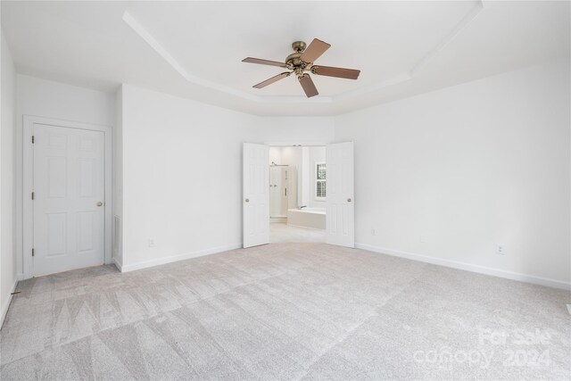 unfurnished bedroom featuring ceiling fan and light carpet