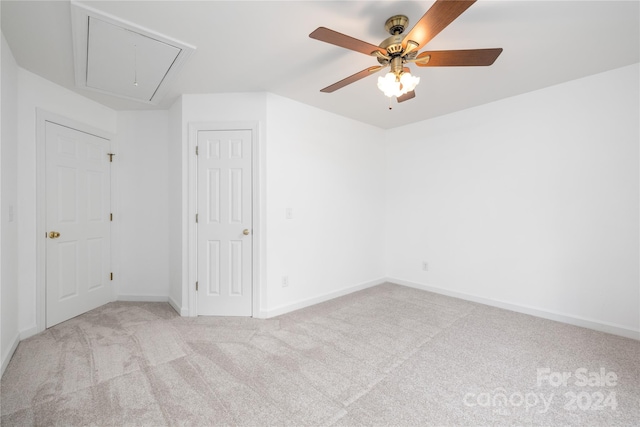 empty room with ceiling fan and light colored carpet