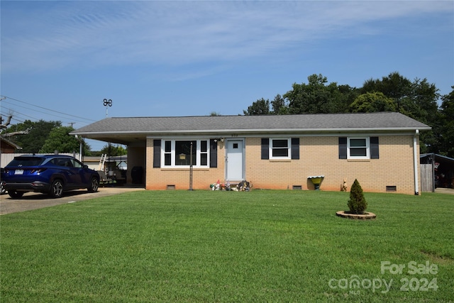 view of front of property with a front lawn and a carport