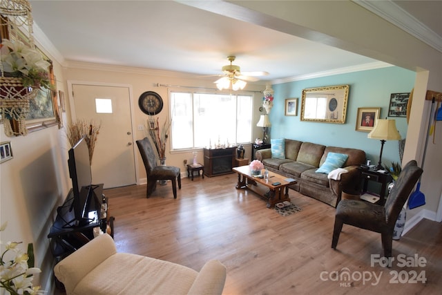 living room with ornamental molding, a ceiling fan, and wood finished floors
