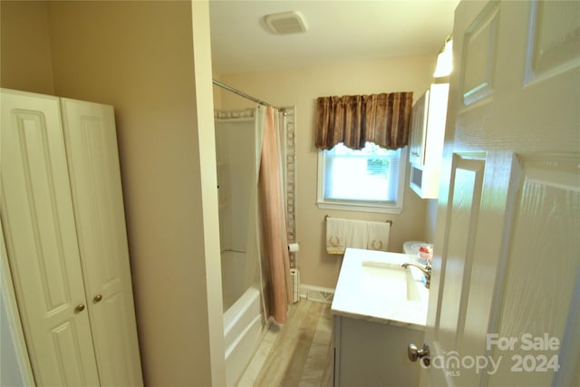 bathroom featuring visible vents, shower / bath combination with curtain, and vanity