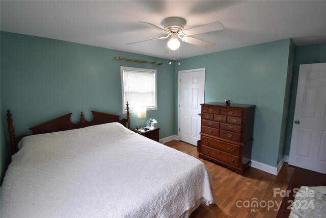 bedroom with ceiling fan and hardwood / wood-style flooring