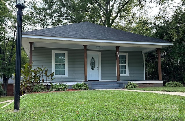 bungalow-style house featuring a porch and a front yard