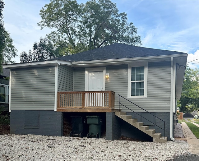 back of house with roof with shingles