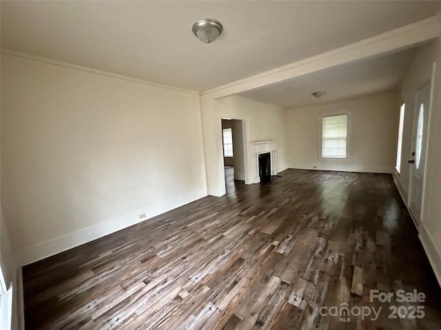 unfurnished living room with dark wood-style floors, a fireplace, and a healthy amount of sunlight