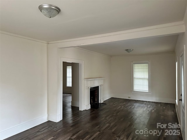 unfurnished living room featuring a fireplace, dark wood finished floors, and crown molding