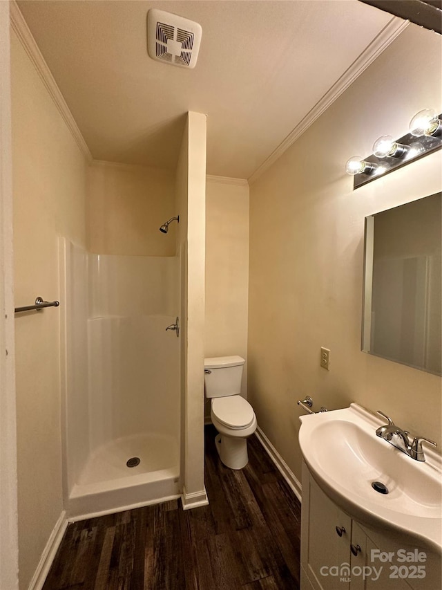 bathroom with toilet, wood finished floors, visible vents, walk in shower, and crown molding