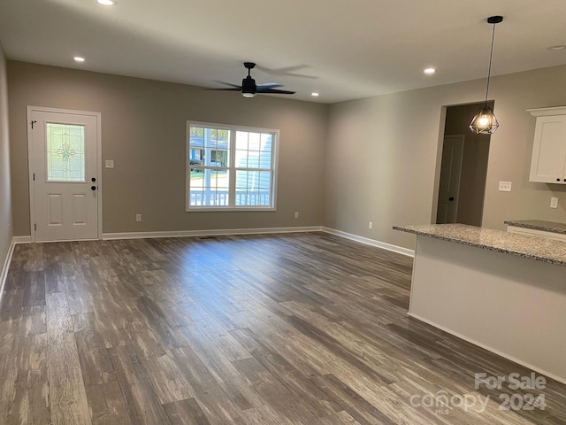 unfurnished living room featuring baseboards, ceiling fan, dark wood finished floors, and recessed lighting