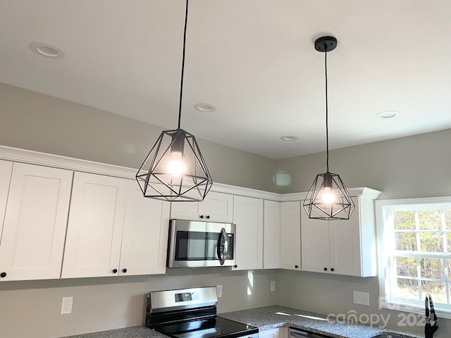 kitchen with stainless steel appliances, recessed lighting, white cabinets, and decorative light fixtures