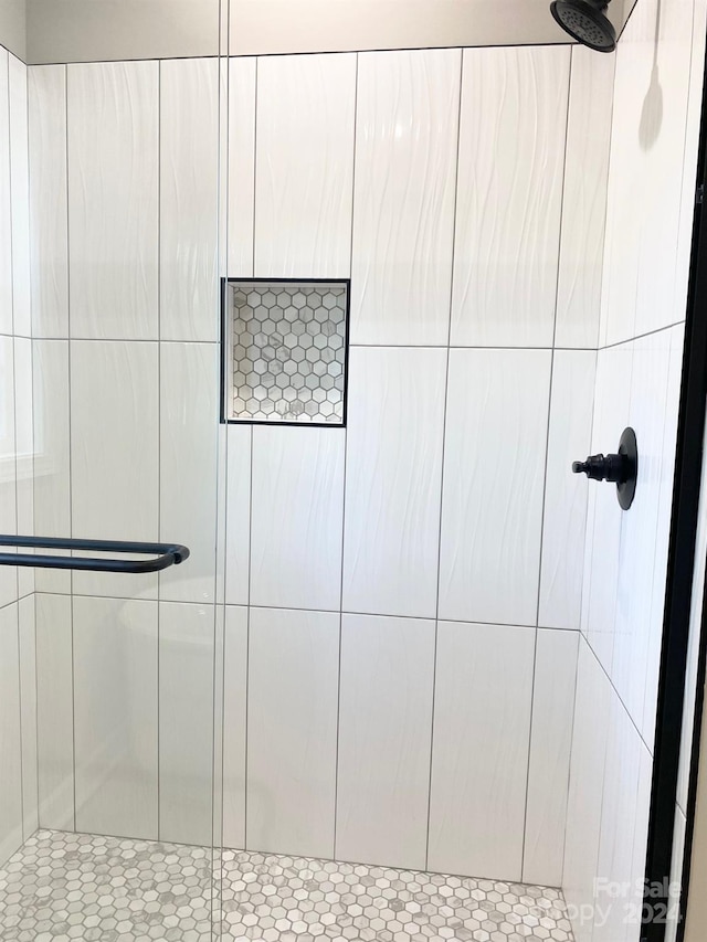 interior details featuring a tile shower