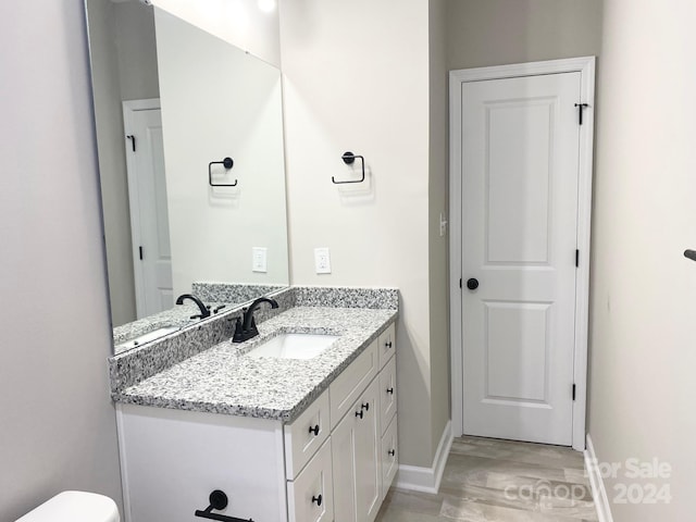 bathroom with vanity and baseboards