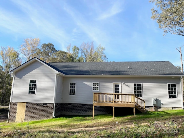 rear view of property with crawl space, a yard, and a wooden deck