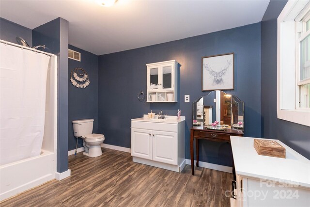 full bathroom with shower / bath combination with curtain, vanity, toilet, and hardwood / wood-style flooring