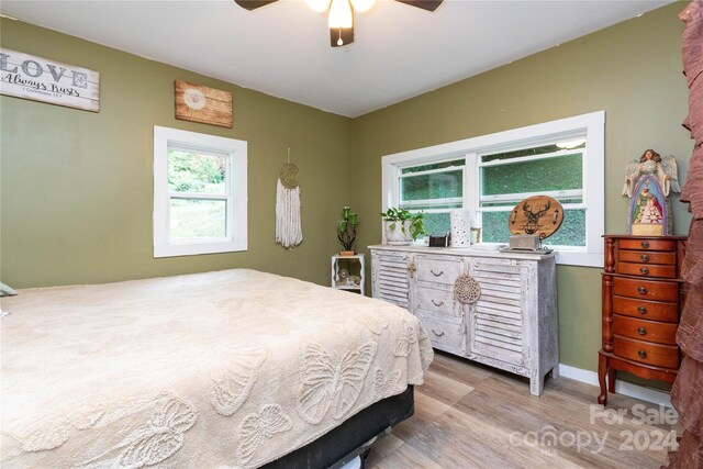 bedroom with ceiling fan and light hardwood / wood-style floors