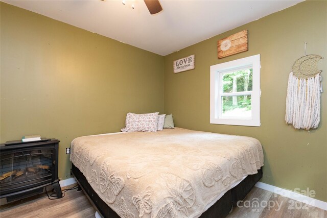 bedroom with ceiling fan and hardwood / wood-style flooring