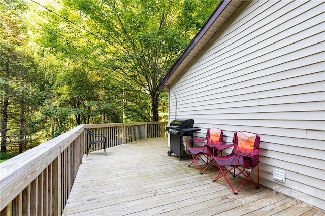 wooden terrace featuring grilling area