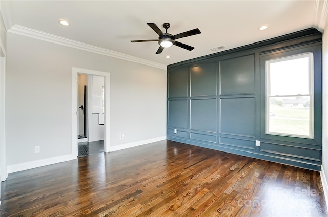 spare room with dark hardwood / wood-style flooring, ceiling fan, and ornamental molding